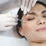 Young woman lying with closed eyes during botox